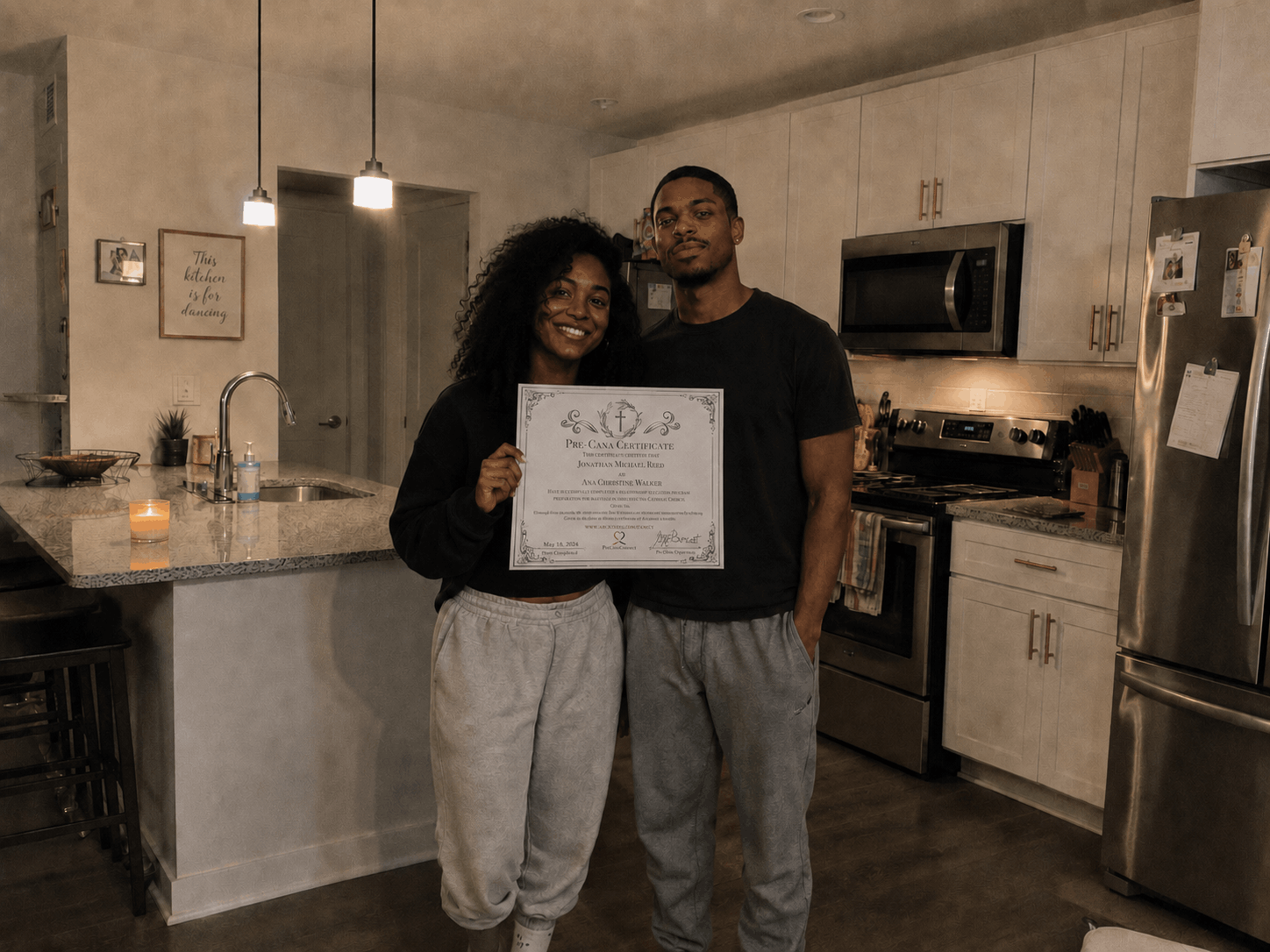 Jonathan R. and Ann W. with their Pre-Cana certificate of completion in their kitchen, Atlanta, GA